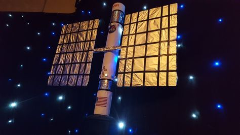 Satellite made from carpet tube, cardboard and foil. Space Station Decorations, Space Vbs Decor, Vbs 2023 Stellar, Stellar Vbs Decorations, Vbs Stellar Decorations, Vbs Space Theme Decorations, Nasa Decor, Stellar Vbs 2023 Decorations, Outer Space Vbs