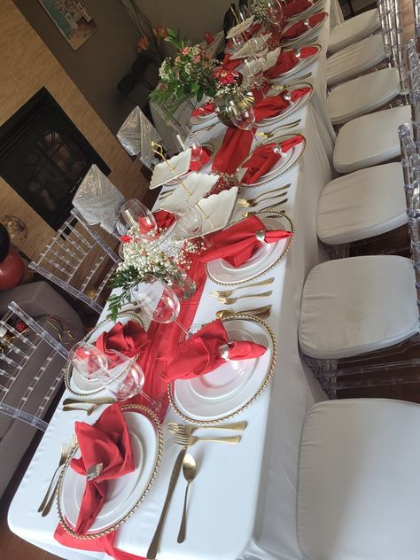 White tableclothe Red table runner Flower arrangement centerpieces Clear chiavari chairs Flower Arrangement Centerpieces, Clear Chiavari Chairs, Table Runner Flower, Red Table Runner, Graduation Brunch, Diy Event, Chiavari Chairs, Red Table, Red Decor