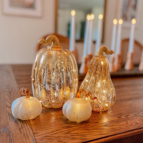 This set of 3 white glass pumpkins were created as a modern update for classic fall decoration. Each pumpkin emits a warm white light, with a single LED shining through the distinct mercury glass finishing. Great for indoor use in an autumn tablescape, mantle or console display. This battery operated set of three adds a festive glow to bookshelves, a dining sideboard, or next to the kitchen fruit basket. Perfect for an elegant Thanksgiving dinner party, adding a touch of glamor in a traditional Thanksgiving Dinner Table Decor, Mercury Glass Pumpkins, Fall Room Inspiration, Fall Aesthetic Decor, Fall Room Decor Ideas, Thanksgiving Dinner Table Decorations, Dinner Tablescape, Console Display, Indoor Lanterns