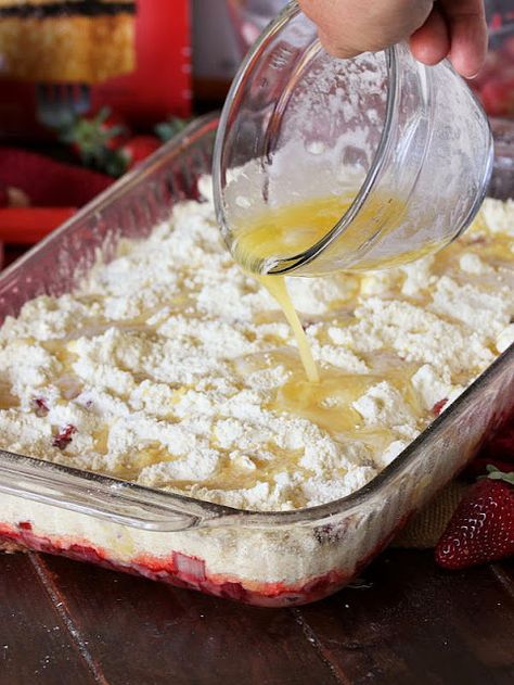 Drizzling Strawberry Rhubarb Dump Cake with Melted Butter Image Strawberry Rhubarb Pound Cake, Strawberry Rhubarb Dump Cake Recipes, Rhubarb Dump Cake With Jello, Strawberry Rhubarb Dump Cake, Rhubarb Dump Cake, Strawberry Rhubarb Cake, Rhubarb Pudding Cake, Strawberry Rhubarb Pie Filling, Easy Rhubarb Recipes