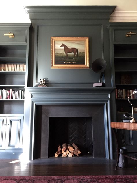 Dark Formal Living Room, Off Center Fireplace Vaulted Ceiling, Dark Blue Fireplace Mantle, Foe Fireplace, Molding Above Fireplace, Dark Fireplace Wall, Study Fireplace, Moody Fireplace, Paneled Fireplace