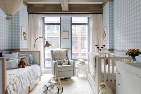 Glider rocker in front of large windows between daybed and crib in nursery with blue and white gingham walls. Crib And Daybed In One Room, Nyc Nursery, Nursery Daybed, Daybed Room, Dreamy Nursery, Changing Table Dresser, Glider Rocker, Unisex Nursery, Playful Decor