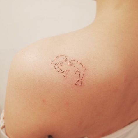 ©wittybutton_tattoos Two Dolphins Tattoo, Fine Line Dolphin Tattoo, Dolphin Tattoo For Women, Dolphin Tattoos, Dolphin Tattoo, Wrap Around Tattoo, Dolphins Tattoo, Beach Tattoo, Pink Dolphin