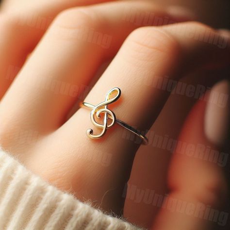 *Free engravings up to 20 characters* Harmonize your style with this minimalist music note ring! 🌟 It's a melodious adornment for your finger or a perfect gift for anyone who cherishes the beauty and rhythm of music. 🎵💕 This ring, perfect for stacking or as a solo symbol of your love for music, captures the elegance of a treble clef. Beautifully crafted, it features a minimalist music note design along a delicate band, symbolizing the universal language of melodies and harmonies. Whether you're a musician or a music lover, this music note ring is a charming and meaningful choice, ready to accompany you on every musical endeavor.  band width: 1.5mm Feel free to message us for customization! We can usually make minor alterations at no added charge. Covered by full warranty for 3 months af Piano Ring, Music Jewelry Rings, Presents For Music Lovers, Gift For Musician, Band Stuff, Gifts For Musicians, Treble Clef Ring, Music Themed Jewelry, Music Note Ring