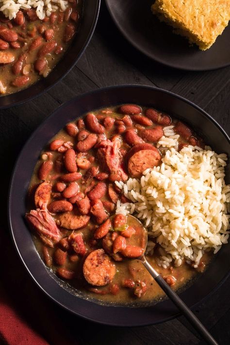 This New Orleans Red Beans and Rice recipe is the epitome of southern comfort food! It's a classic Louisiana Creole dish made with the "holy trinity", andouille sausage, and smoked ham hocks and is inspired by Buster Holmes and Louis Armstrong. New Orleans Red Beans, Smoked Ham Hocks, Slow Cooker Red Beans, Red Beans And Rice Recipe, Red Beans N Rice Recipe, Ham Hocks, New Orleans Recipes, Louisiana Hot Sauce, Red Beans And Rice