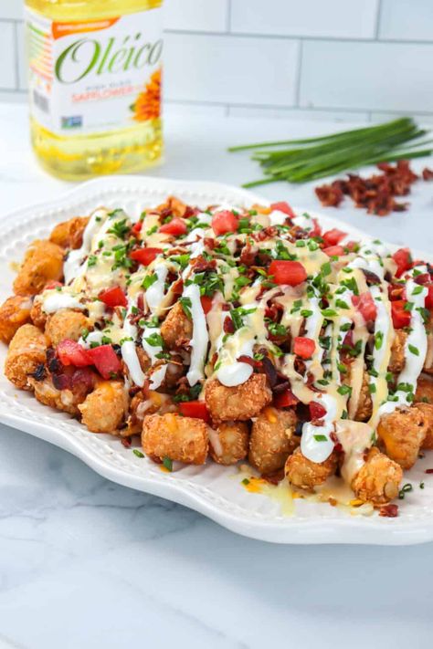 This loaded tater tot recipe is a deliciously cheesy appetizer or snack to serve on game day! Loaded Tater Tots Recipes Pulled Pork, Homemade Loaded Tater Tots, Loaded Cheesy Tater Tot Cups, Loaded Tarot Tots, Tater Tot Recipe, Vegetarian Loaded Tater Tots, Loaded Tater Tot, Loaded Tater Tots, Tater Tot Recipes