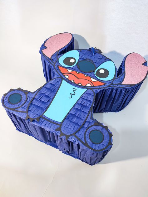 Pinata Stitch from the movie Lilo&Stitch, a perfect decoration for a Hawaiian birthday, available in a classic and pull string version. Made with attention to the smallest detail. Its height is up to 50 cm. The piñata is sold without filling, but has a hidden lid through which you can pour sweets. A perfect surprise for the birthday boy and great fun for children and adults Stitch Lilo And Stitch, Lilo Und Stitch, Hawaiian Birthday, Lilo Et Stitch, Birthday Decoration, Birthday Boy, Lilo And Stitch, The Movie, Birthday