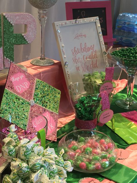 Blinged AKA grad cap & candy table Aka Sorority Centerpieces, Aka Table Decorations, Aka Centerpieces, Pink And Green Graduation Party, Aka Grad Pictures, Grad Photoshoot Ideas, Aka Sorority Grad Chapter, Happy Incorporation Day Aka, Aka Party