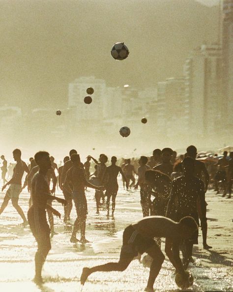 Dive into the heart of Rio de Janeiro's iconic beaches through the lens of Rafael Moura. As the golden sands come alive with locals and tourists alike, a group engrosses in a spirited game of beach ball. Their silhouettes, moving in harmony against the backdrop of the vast azure sea, epitomize the city's soulful rhythm. The film's grainy texture magnifies the nostalgia, bringing out the raw emotions and vibrant colors - from the sun-kissed tans to the cerulean waves. Cinematic Dance, Shot On Film, Brand Manual, Principles Of Art, Beach Ball, Cinematic Photography, Summer Feeling, On Film, Elements Of Art