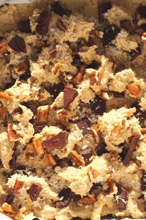 These Keto Cowboy Cookie Bars is an adaptation of a 5/5 star NY Times recipe. These easy low-carb cowboy cookies which have been made into bars taste as they came from a fancy bakery! They are thick and chewy and full of nutty goodness!   Simply combining coconut, pecans, cinnamon and chocolate, these cookie bars make the most flavourful gluten-free and sugar-free keto cookie bars! Low Carb Cowboy Cookies, Keto Cowboy Cookies Recipe, Keto Cowboy Cookies, Cowboy Cookie Bars, Cowboy Bars, Keto Cookie Bars, Fancy Bakery, Cowboy Cookie, Cowboy Cookie Recipe