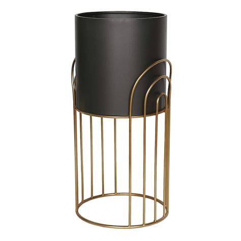 Modern design and unbeatable prices come together at Crosby St. only from At Home. Invite a colorful charming vibe into your home with our medium size 23in. Crosby St. bronze and black planter stand. This interesting piece features a golden/bronze art deco style arched stand to display your favorite plants. Not only for the garden, this black and golden/bronze metal planter stand can be used in an indoor garden room or on the patio as well. Highlight your green thumb and showcase your annuals an Diy Planter Stand, Indoor Garden Rooms, Gold Planter, Diy Planter, Black Planters, Bronze Art, Planter Stand, Metal Planters, Plant Stands