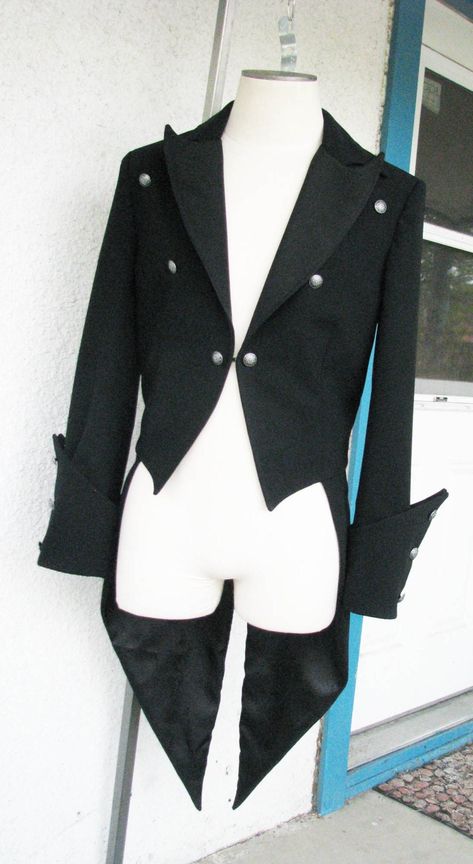 A classic dress coat with gothic detailing. This piece has peak lapels and a curved upper collar so that the points overlap. The fronts of the tailcoat just kiss and finish with a hook and eye. The unique pointed cuffs feature 6 buttons. And the back tightens with a belt. The piece is made from a gorgeous 12oz wool suiting. ----------------------------------- We can make a tailcoat in any style. From steampunk, to Regency, to stunning white tie. Contact us with the details that you would like be Gothic Suit, Wiccan Wedding, Coat Tails, Cloth Designs, Rad Clothes, Fantasy Outfits, Prom Outfits, Dress Coat, Coat Patterns