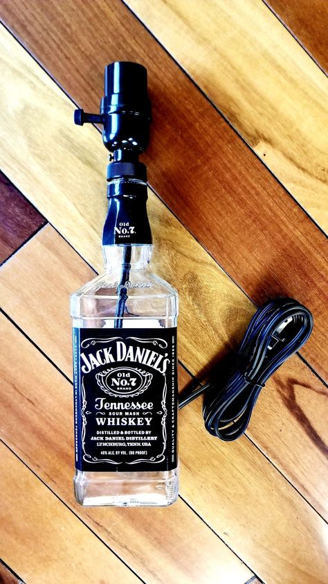 These lamps are hand crafted from up-cycled glass whiskey bottles. They look great in game rooms/bars/dorm rooms/garages or man caves! They make excellent gifts for the whiskey lover in your life! Orders placed before 2pm CST will ship out same day! ~This listing is for the lamp only. It's a  750ml bottle, no bottle filler, bulb or shade and comes with a black cord.~ Check my other listings for more decorative lamp options and various sizes! Whisky Bottle Crafts, Empty Liquor Bottle Ideas, Jack Daniels Lampe, Liquor Bottle Lamps, Whiskey Bottle Lamp, Jack Daniels Lamp, Alcohol Decor, Diy Whiskey, Liquor Bottle Lights