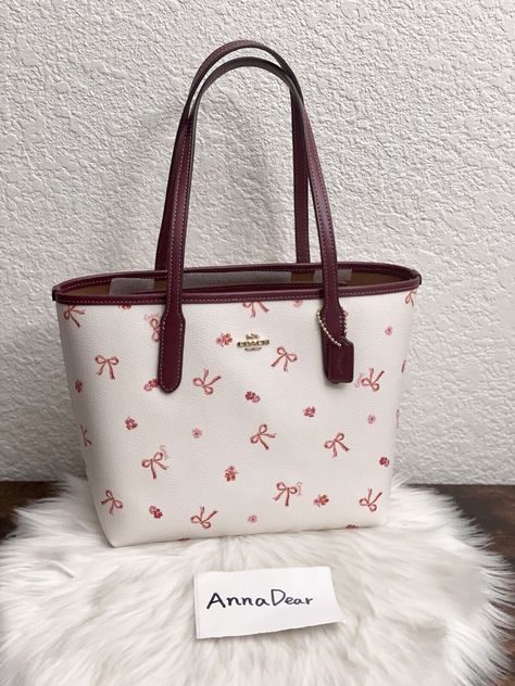 Coach Mini City Tote With Bow Tie Print Brand new with tags Color: Im/Chalk/Wine Multi 100% Authentic Limited Edition Product Details Printed coated canvas and smooth leather Inside snap pocket Handles with 7" drop 9" (L) x 8" (H) x 4 1/4" (W) Style No. CN681 Coach Mini Tote Bag, Coach Mini City Tote, Coach Bow Bag, Coach Bags Tote, Mini Coach Bag, Must Have Bags For Women, Coach Tote Bag Outfit, Cute Coach Bags, Purse For School