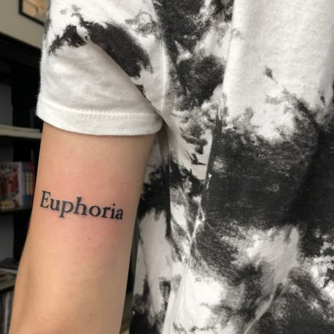 Euphoria Word Tattoo, Euphoria Tattoo Words, Bicep Word Tattoo, One Word Tattoos For Men, Malayalam Tattoo, Euphoria Tattoo Ideas, Noah Tattoo, Euphoria Tattoo, Word Tattoos On Arm