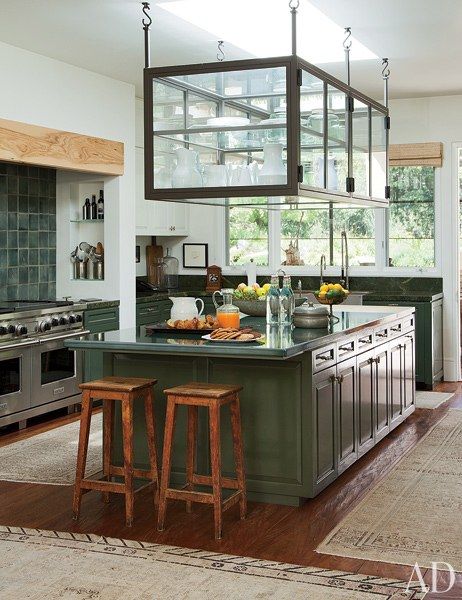 A hanging glass cabinet, suspended above an spacious island, provides both storage space and a striking focal point in the country-chic kitchen at the California home of Ellen DeGeneres and Portia de Rossi. | archdigest.com Celebrity Kitchens, Portia De Rossi, Beverly Hills Houses, Decor Ikea, Hanging Cabinet, Ellen Degeneres, Glass Cabinet, Celebrity Houses, Design Living Room