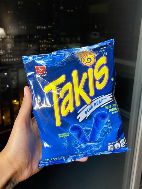 Hand holding small bag of blue heat takis Heat, Blue