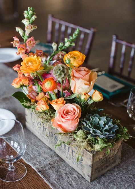 Try this unexpected take on a centerpiece: Plant your stems in aged, wood boxes. A mix of blooms and heights give this arrangement a relaxed, organic feel well suited for a rustic celebration. l <a href="https://www.theknot.com" rel="nofollow" target="_blank">TheKnot.com</a> Orange Centerpieces, Tafel Decor, Boho Inspiration, Rustic Wedding Centerpieces, Deco Floral, Wedding Centerpiece, Floral Centerpieces, Event Styling, Flower Boxes