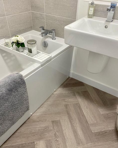 Instead of replacing your bathroom floor, using vinyl flooring will save you money on your bathroom renovation. With a herringbone pattern, it can add a touch of elegance and visual interest to the space. Furthermore, the durable nature of vinyl flooring also makes it a practical choice for high-moisture areas like bathrooms. Vinyl flooring from @mynorthernadventure2022 Bathroom Flooring Ideas Vinyl, Herringbone Bathroom Floor, Herringbone Vinyl Floor, Herringbone Bathroom, Vinyl Flooring Bathroom, White Marble Tiles, Tiles For Bathroom, Vinyl Floors, Herringbone Floor