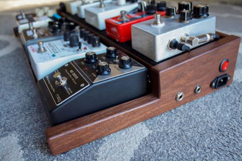 Custom walnut pedal board for guitar effects pedals. It is inspired by wooden end caps on vintage synthesizers and has an  underside mounted power supply and wired input/ouput jacks on one side panel. Wood Pedalboard, Vintage Synthesizers, Pedalboard Design, Pedalboard Ideas, Diy Pedalboard, Guitar Pedal Board, Guitar Pedal Boards, Diy Guitar Pedal, Dovetail Box