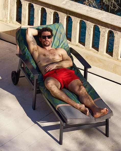 Man on sun lounger wearing primary red swim shorts. This image was included in the article: 8 Major Men’s Swimwear Trends For Summer 2023, on MensFlair.com Trends For Summer 2023, Summer Co Ords, Poolside Style, Tonal Prints, Poolside Fashion, Saturdays Nyc, Swimwear Trends, Men's Swimwear, Mens Loungewear