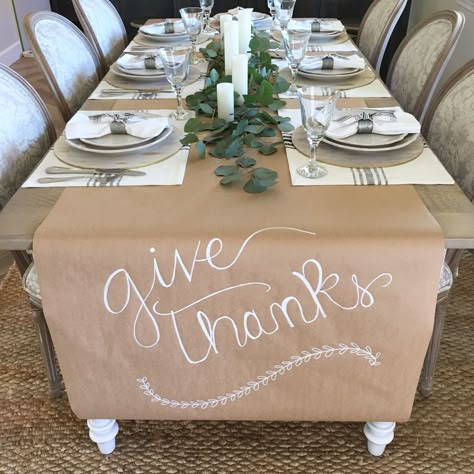 Thanksgiving easy table setting. Kraft paper runner.  Magnolia home placemats. Fresh eucalyptus and candles Low Budget Thanksgiving Table Decor, Butcher Paper Food Display, Thanksgiving Craft Paper Table Runner, Thanksgiving Set Up For Large Family, Silver Thanksgiving Table Decor, Diy Friendsgiving Decor, Mexican Thanksgiving Decor, Simple Dinner Party Table Decor, Thanksgiving Table Butcher Paper