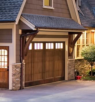 Russ: Like overhang size and alternate texture.  Also the timber support on garage. Garage Corbels Ideas, Gable Exterior Design, Decorative Garage Overhang, Overhangs For Front Door, Garage Door Portico, Wood Awnings Over Garage Doors, Garage Door Roof Overhang, Roof Over Door Entrance, Wood Overhang Entrance