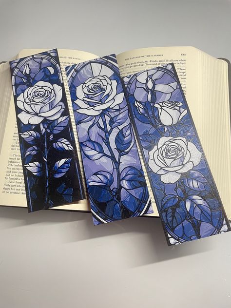 Introducing our exquisite Stained Glass Rose Bookmark Pack of 3 - a collection that merges the beauty of stained glass art with the timeless elegance of roses. Elevate your reading experience with these stunning bookmarks, each crafted to add a touch of sophistication to your favorite books. 🌹 Immerse yourself in the enchanting world of literature with our Stained Glass Rose Bookmarks. Each bookmark features a meticulously designed rose in the style of stained glass, creating a visual masterpiece that captures the essence of both art and nature. 📚 This pack includes three distinct bookmarks, allowing you to infuse your reading routine with the captivating charm of stained glass roses. Let these bookmarks grace the pages of your novels, journals, or poetry collections, marking your place Stained Glass Bookmark, Bookmark Shapes, Artistic Bookmarks, Book Mark Designs, Aesthetic Bookmark Ideas, Bookmark Design Ideas, Bookmarks Design, Bookish Crafts, Rose Bookmark