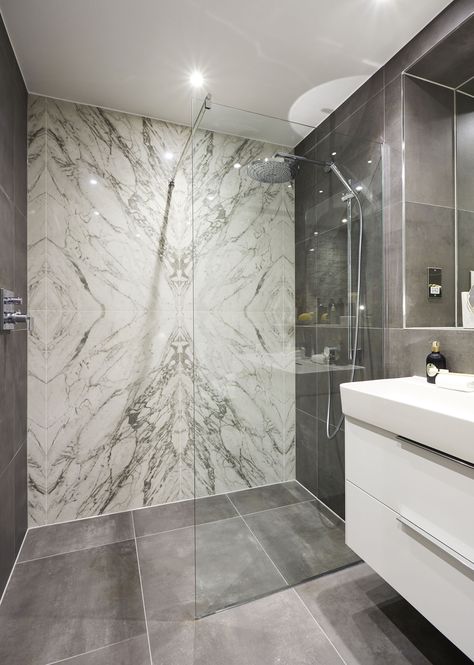 Incredible Minoli marble-effects stand as a grand feature in the shower room of this exclusive penthouse apartment.  Use this amazing book match marble-look tile from Minoli Marvel, for rooms of luxury, state-of-the-art style.  #minoli #tiles #bookmatch #bookmark #bookmatchtiles #bookmarktiles #bookmatchmarble #bookmarkmarble #statuario #statuariomarble #whitemarble #whitemarbleeffects #showertiles #luxurytiles #luxuryinterior Brass Dining Table, Wooden Columns, Inner Sanctum, Vogue Living, Home Luxury, Hotel Boutique, Furniture Showroom, Minimalist Bathroom, Marble Bathroom