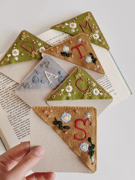 All stitched, wrapped and packed- personalized, hand embroidered corner bookmarks🔖 #moodygreenembroidery #handembroidery #floralembroidery #personalized #needlework #bookstagram #reading #booklovers #bookmark #etsy #etsyshop #etsyseller #etsyfinds #etsygifts #handcrafted Felt Corner Bookmarks Diy, Homemade Baby Shower Favors, Embroidered Corner Bookmark, Embroidered Bookmarks, Felt Bookmark, Diy Monogram, Miniature Embroidery, Personalised Gifts Diy, Digital Embroidery Patterns