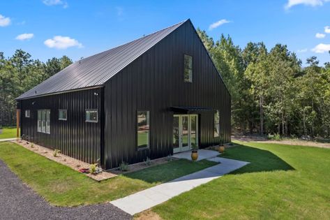 Black Barndo, Texas Barndominium, Stilt Home, Wooden Homes, Black Barndominium, Wooden Trim, Open Living Area, Wooden Front Doors, Barndominium Floor Plans