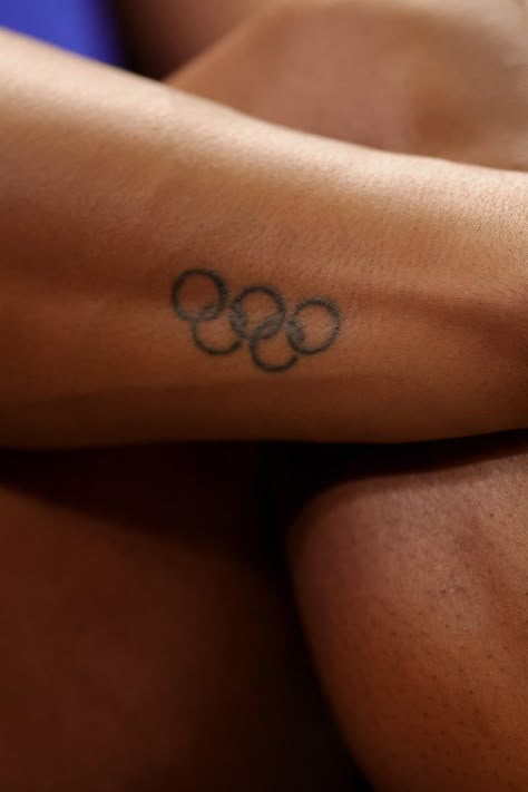 Track And Field Tattoos Ideas, Olympic Tattoo Ideas, Olympic Motivation, Tattoos For Athletes, Olympian Aesthetic, Olympic Rings Tattoo, Athlete Tattoos, Track Tattoo, Inside Ankle Tattoos