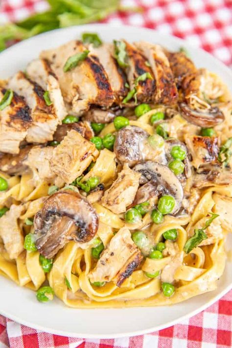 Pasta Carrabba Copycat Recipe – copycat recipe from our favorite restaurant! Italian grilled chicken over Alfredo with peas and mushrooms – my husband wanted to lick his plate! Chicken, balsamic vinegar, olive oil, basil, butter, shallots, garlic, parmesan, heavy cream, mushrooms, green peas, and fettuccine. Seriously delicious! Serve with a salad and bread for a meal better than any restaurant! Pasta Carrabba Recipe, Alfredo With Peas, Italian Grilled Chicken, Carrabbas Recipes, Peas And Mushrooms, Basil Butter, Restaurant Italian, Pasta With Peas, Creamed Peas