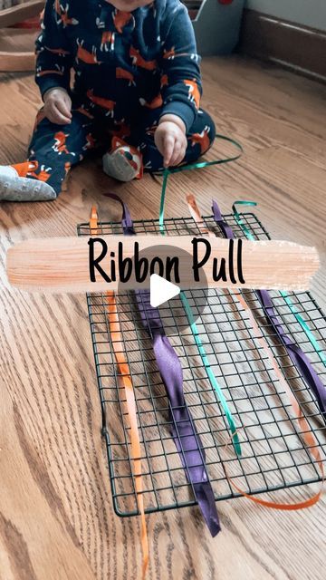 Brittany | Kids/Toddler/Baby Activities | Check out this quick and easy baby activity created with common household items!  For this activity, loop ribbons through a cookie coolin... | Instagram Baby Activity, Baby Activities, Cooling Rack, Busy Board, Educational Games, Infant Activities, Toddler Activities, Household Items, Cookies Et Biscuits