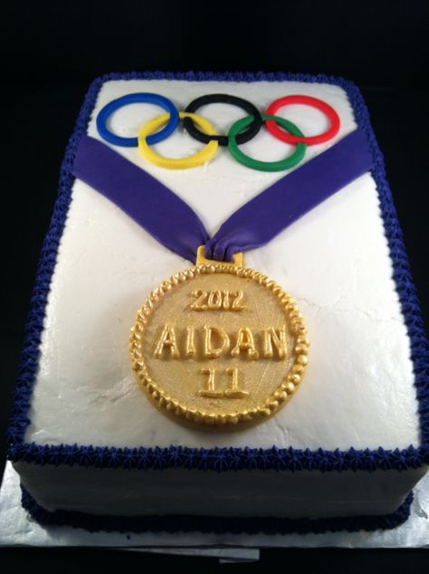 Olympic themed birthday cake made for 11th birthday.  Iced in Buttercream.  Fondant rings, chocolate medal with luster dust. Chocolate Medals, Olympic Theme Party, Gymnast Birthday Party, Buttercream Fondant, Gymnastics Birthday, Olympic Party, Cakes And Cookies, Luster Dust, Golden Birthday