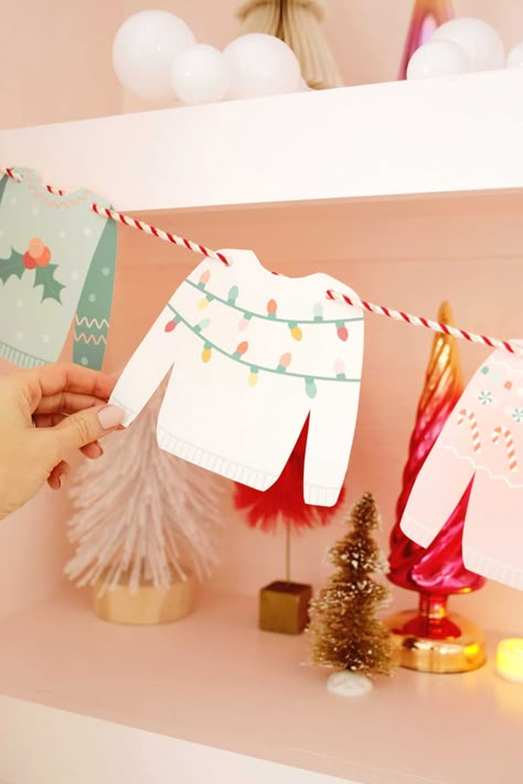 Christmas Sweater Garland DIY (With Free Printable!) - A Beautiful Mess Cricut Christmas Garland Ideas, Christmas Decorating Party Ideas, Holiday Banners Diy, Diy Christmas Banner Ideas, Cricut Crafts Christmas, Christmas Decor Printables Free, Ugly Sweater Templates Free Printable, Camper Christmas Decorations, Christmas Garland Printable