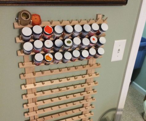 This is the basis for my storage rack, its a sewing thread rack I rescued from a thrift store. It fits both the apple barrel craft type paints and the shorter model round paints for painting model cars and things like that. The thread spools are meant to slip over the pegs, I slide paint bottles between the pegs. Toy Storage Wall Unit, Paint Storage Diy, Apple Barrel Paint, Paint Organizer, Craft Paint Storage, Painting Storage, Shoe Storage Small Space, Thread Rack, Paint Rack