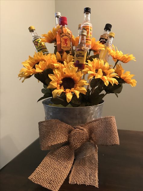 21st birthday bouquet #21stbirthday #birthday #alcohol #sunflower #burlapbow Flowers And Alcohol Gift, Sunflower 21st Birthday Party, Flower Bouquet With Alcohol, Sunflower Gift Ideas Birthday, 21st Birthday Centerpiece Ideas, Alcohol Centerpieces, 21st Birthday Bouquet, 21st Birthday Table Decorations, Birthday Flower Arrangements