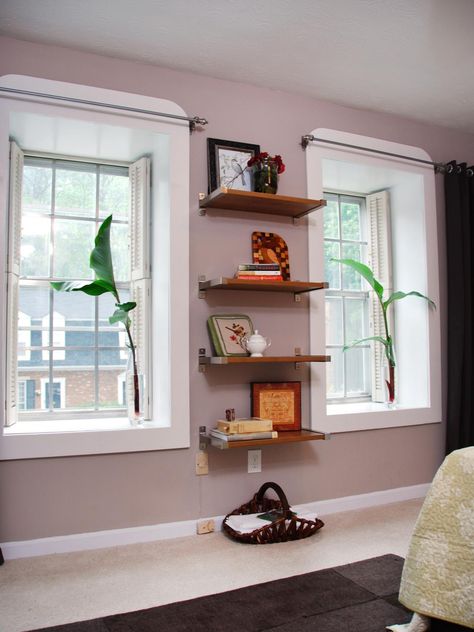 Decorating with Floating Shelves | Interior Design Styles and Color Schemes for Home Decorating | HGTV Space Between Windows Decorating, How To Decorate Between Two Windows, Floating Shelves Between Windows, Floating Shelves Around Window, Between Windows Decor, Shelves Between Windows, Wall Between Two Windows, Dining Library, Vertical Shelves