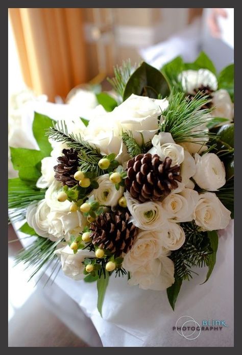 A white rose and pine cone bouquet nicely blends the traditional and unique, adding a classy touch to your fall-themed wedding. Cheap Wedding Flowers, Red Bouquet Wedding, Winter Wedding Bouquet, Flowers And Greenery, Winter Bouquet, Winter Wedding Flowers, Winter Bride, White Bridal Bouquet, White Wedding Bouquets