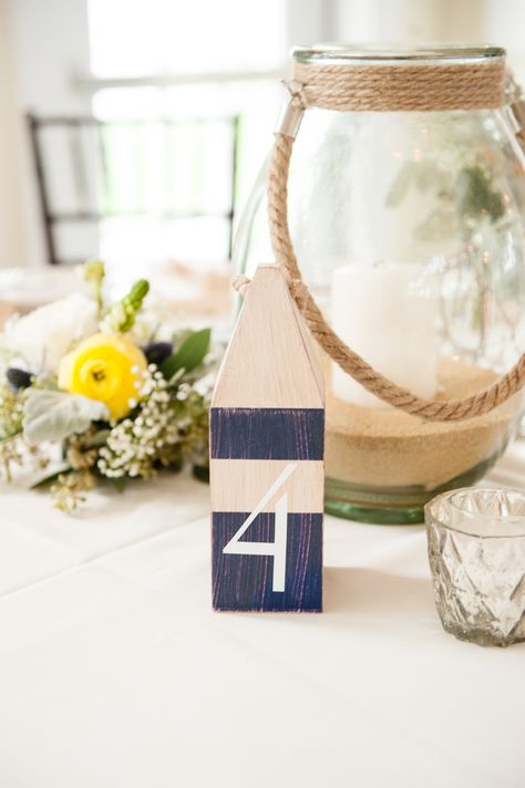 Nautical Centerpiece, Buoy, Table Number, Lantern, Candle, Sand, Flowers. Chesapeake Bay Beach Club, Maryland. Photo by Kimberly Brooke Photography Buoy Table Numbers Wedding, Buoy Wedding Centerpiece, Nautical Centerpiece, Nautical Bar, Chesapeake Bay Beach Club, Sea Wedding, Lantern Candle, Maine Wedding, Silent Auction