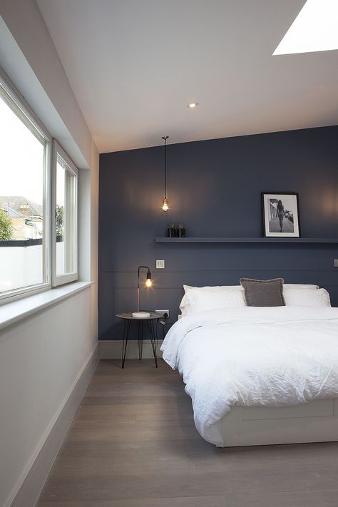 A master bedroom with a blue feature wall Blue And White Bedroom Master Accent Wall, Industrial Blue Bedroom, Grey Blue Accent Wall Bedroom, Bedroom Dark Feature Wall, Dark Blue Bedroom Ideas For Couples, Grey And Blue Bedroom Master Accent Walls, Dark Bedroom Feature Wall, Bedroom Dark Blue Accent Wall, Blue Industrial Bedroom