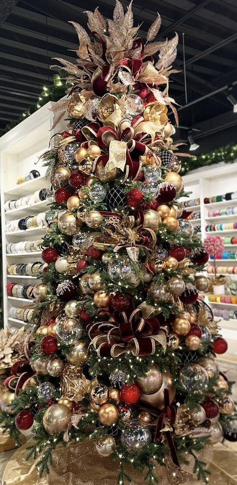 White Gold And Burgundy Christmas Tree, Flocked Tree With Green And Gold, Dark Green Red And Gold Christmas Tree, Bronze Red Christmas Tree, Silver Gold Burgundy Christmas Tree, Green And Maroon Christmas Tree, Red Gold And Copper Christmas Tree, Christmas Tree With Florals, Dripping Crystal Christmas Tree