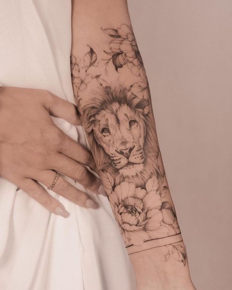 50 Eye-Catching Lion Tattoos That’ll Make You Want To Get Inked - KickAss Things Lion Tattoo With Flowers, Mutterschaft Tattoos, Lion Tattoo Ideas, Female Lion Tattoo, Lower Arm Tattoos, Wreath Tattoo, Lioness Tattoo, Lion Tattoo Sleeves, Lion Tattoos