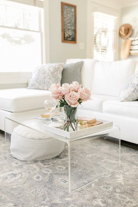 Clear acrylic coffee table in living room with white sectional and vintage rug with muted tones Coffee Table Styling Living Rooms, Clear Coffee Table, White Sectional, Acrylic Coffee Table, Table Decor Living Room, Small Apartment Living Room, English Cottage, Living Room Decor Apartment, Living Room Coffee Table