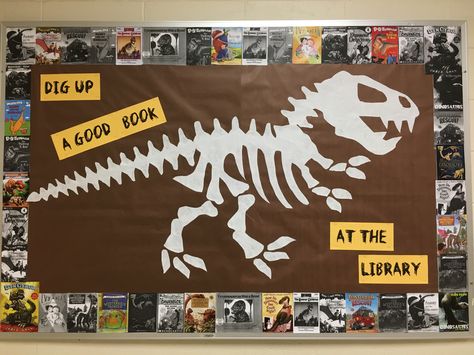 "Dig Up a Good Book at the Library" bulletin board Dinovember Library Display, Dinovember At The Library, Dinosaur Bulletin Board Ideas, Dinosaur Bulletin Boards, Dinosaur Classroom, Kindergarten Library, Dinosaur Activities Preschool, Christian Bulletin Boards, Scholastic Book Fair