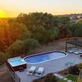 Oval Pool Deck Ideas Above Ground, Above Ground Pool With Deck Off House, Above Ground Swimming Pool Deck, Above Ground Pool Deck, Oval Pool, Relaxing Backyard, Swimming Pool Decks, Sloped Yard, Pool Deck Ideas