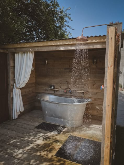 We built a bath cabin from reclaimed materials and installed a lucrious double ended tin bath and an copper shower Diy Outdoor Bathhouse, Outdoor Shower And Tub Ideas, Outdoor Shower Off Grid, Rustic Outdoor Bathroom Ideas, Outside Bathtub Ideas, Outside Showers Diy, Outdoor Shower Floor Ideas, Outdoor Shower Aesthetic, Outdoor Bath House