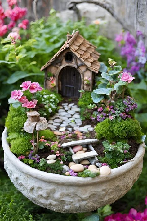 A miniature fairy house with a rustic, wooden exterior, nestled among a lush, green garden filled with vibrant flowers, moss, and other enchanting details. Fairy Porch Ideas, How To Make Fairy Garden, Raised Fairy Garden Ideas, Fairy Backyard Ideas, Fairy Garden Tree Stump, How To Make A Fairy Garden, Dream Garden Fairytale, Small Fairy Garden Ideas, Birdbath Fairy Garden