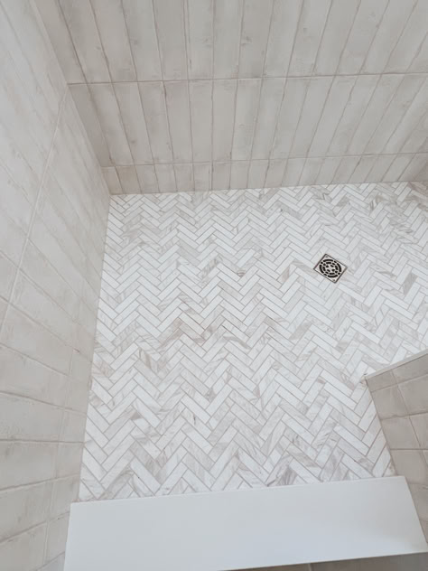 Master bath design. Shower tile. Bath tile. Herringbone tile. White tile bathroom. Walk in shower. White Herringbone Shower Floor, Bathroom Shower Tile Ideas Walk In Herringbone Pattern, Primary Bathroom Shower Tile, Primary Bathroom Tile Ideas, Herringbone Tile Shower Floor, Shower Tile Herringbone, Bathroom Floor And Shower Tile Matching, White Herringbone Shower Tile, Vertical Tile Shower Ideas